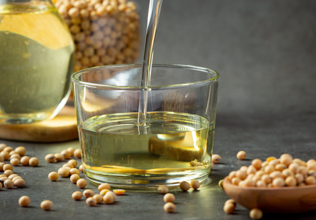 Soybeans and soybean oil with food and beverage products, illustrating nutrition and biofuel feedstock concept
